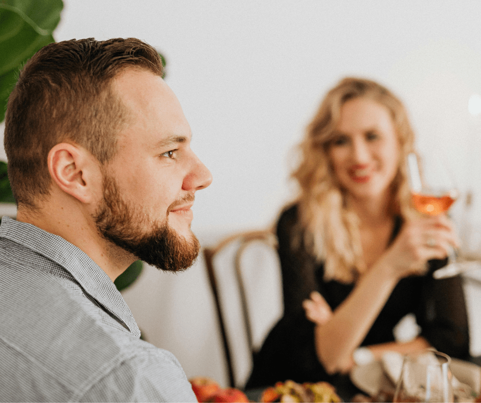 Woman gazing at a man during a romantic dinner, seated at an elegant table with wine glasses Woman gazing at a man during a romantic dinner, seated at an elegant table with wine glasses
