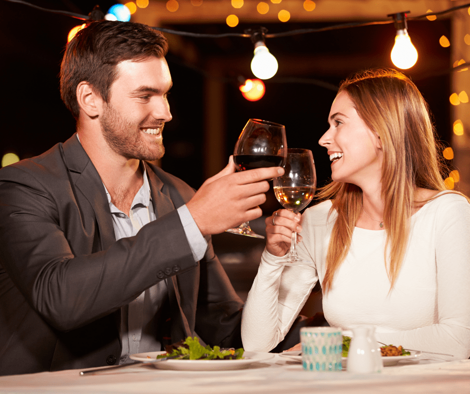 Newlywed couple enjoying a romantic candlelit dinner to celebrate their first year anniversary