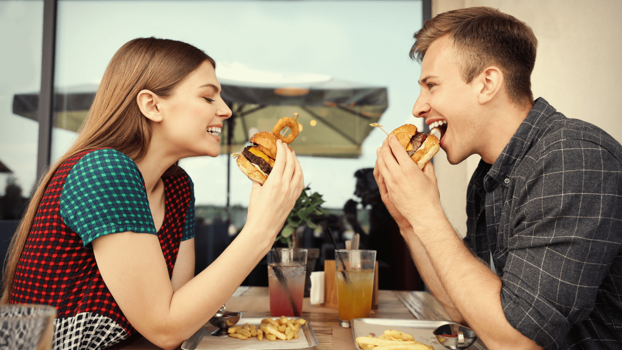 Young couple enjoying eating together at a café