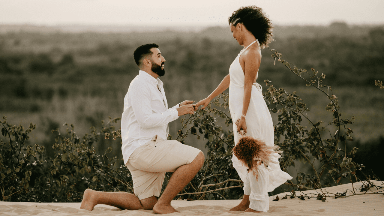 Man kneeling and proposing to woman on beach Man kneeling and proposing to woman on beach