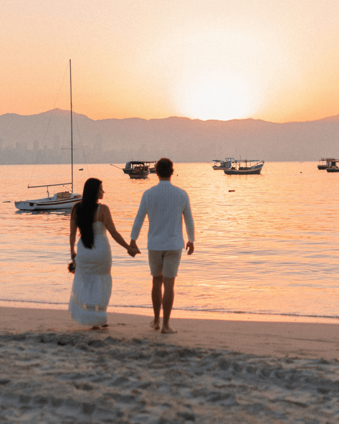 Couple walking on a beach at sunset, symbolizing marriage counseling and stronger relationships
