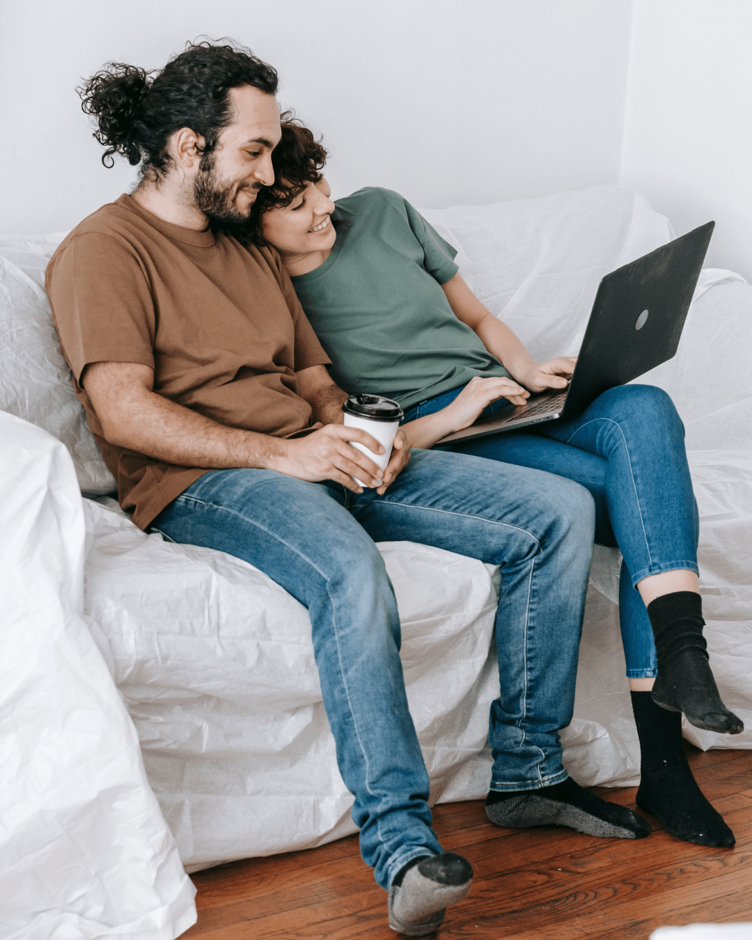 Partners sharing a positive moment while preparing for an online couples therapy session focused on relationship growth