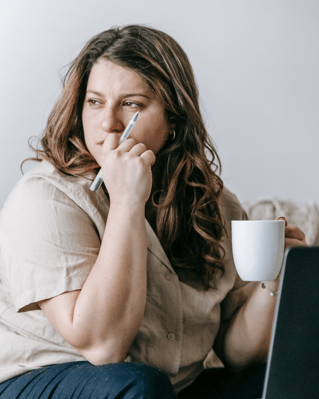 Woman reflecting on relationship anxiety during an online therapy session