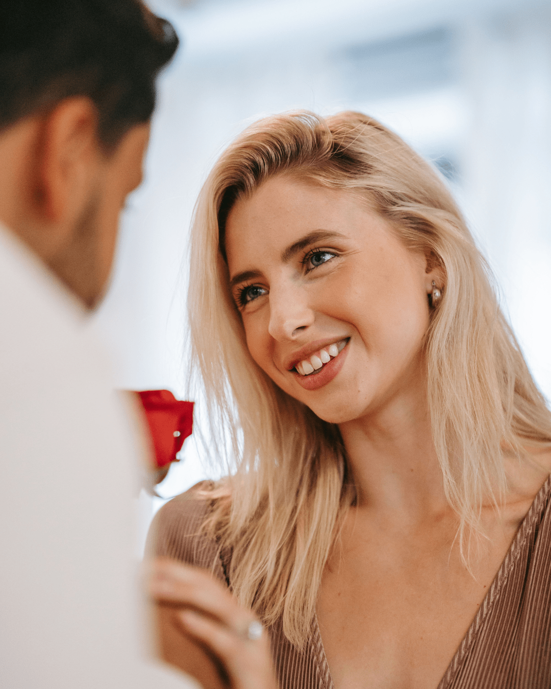 Couple sharing a loving moment together with a red rose